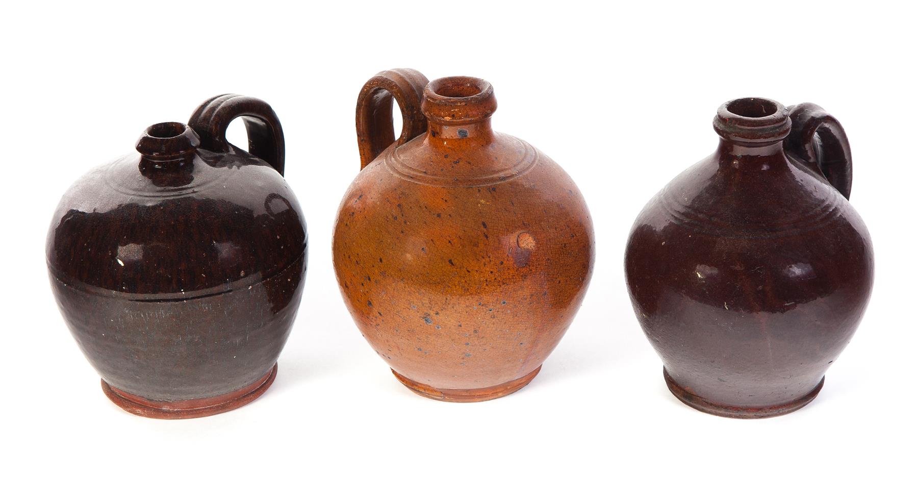 Appraisal: THREE AMERICAN REDWARE JUGS Mid th century Ovoid with tooled