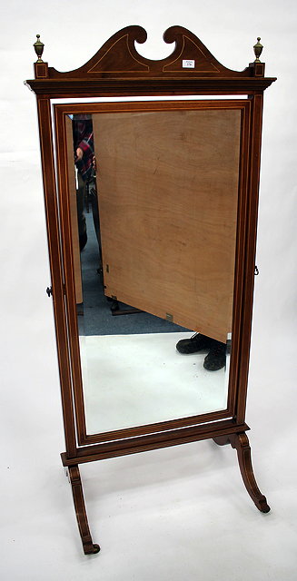 Appraisal: AN EDWARDIAN MAHOGANY CHEVELLE MIRROR with break arch pediment and