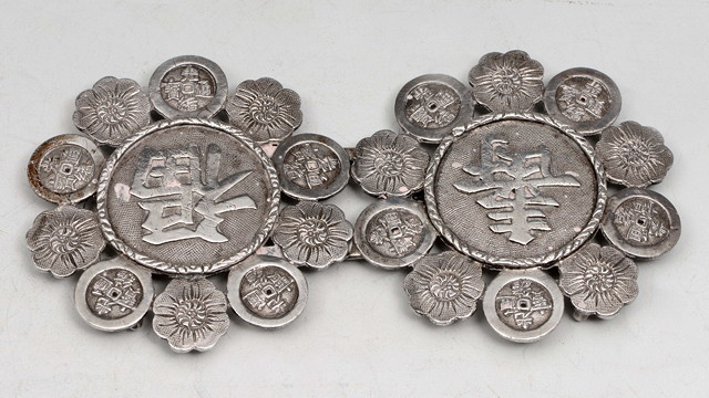 Appraisal: A CHINESE SILVER BUCKLE with floral decoration and characters Shou