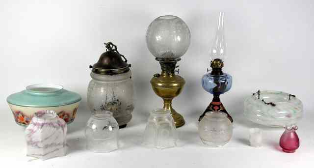 Appraisal: A brass oil lamp with etched glass shade four other