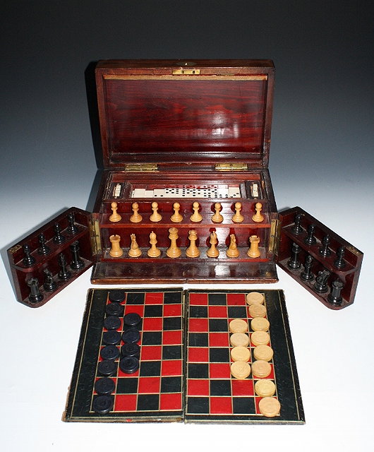 Appraisal: A MAHOGANY GAMING COMPENDIUM for chess dominoes backgammon and draughts