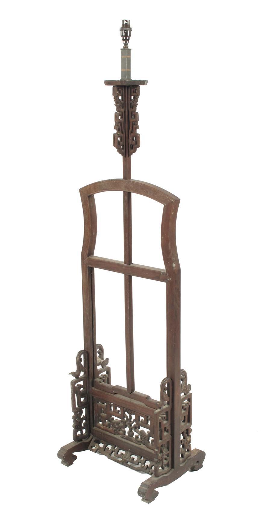 Appraisal: A Chinese carved hardwood adjustable standard lamp