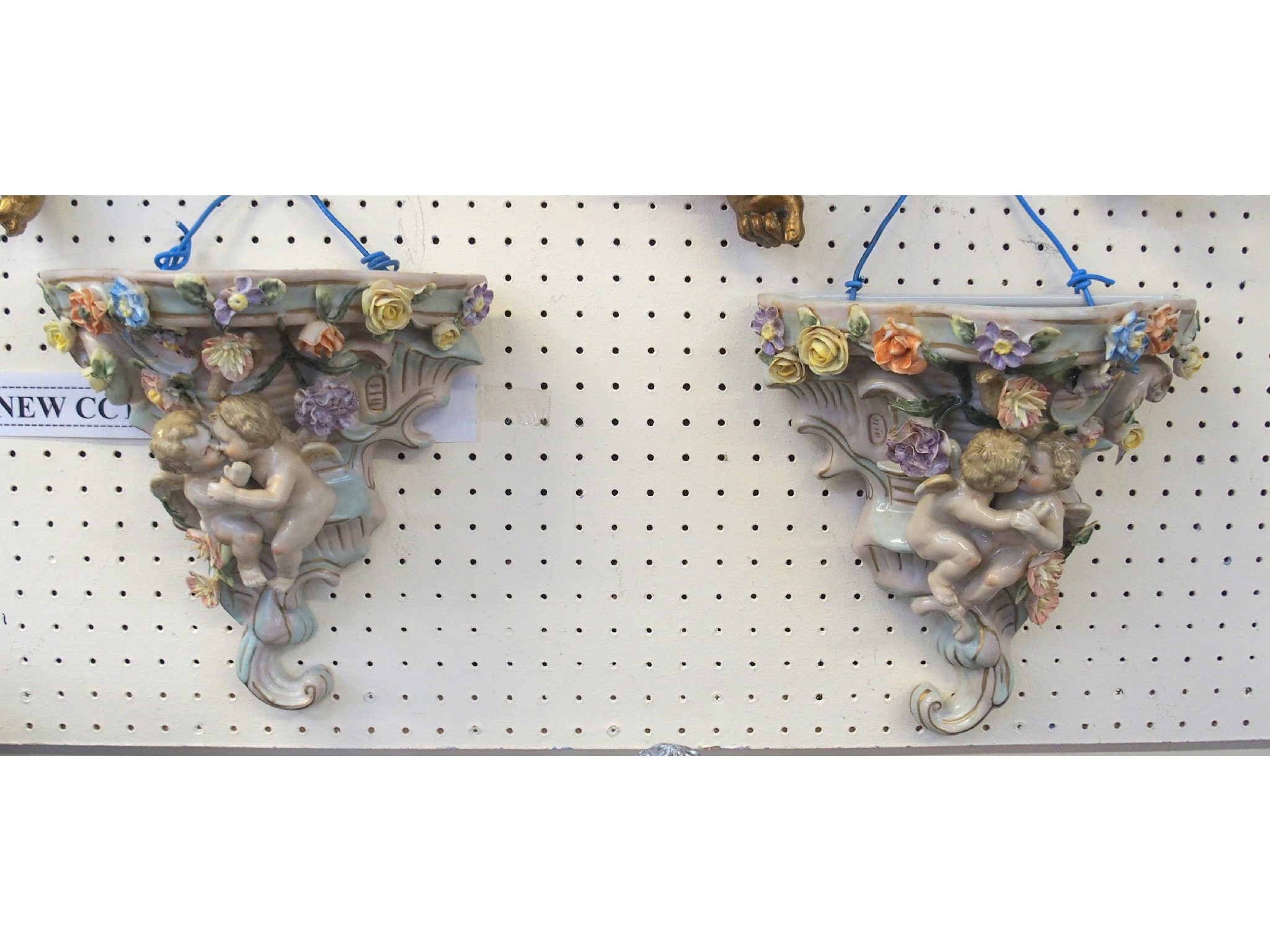 Appraisal: Pair of ceramic wall pockets decorated with cherubs and flowers