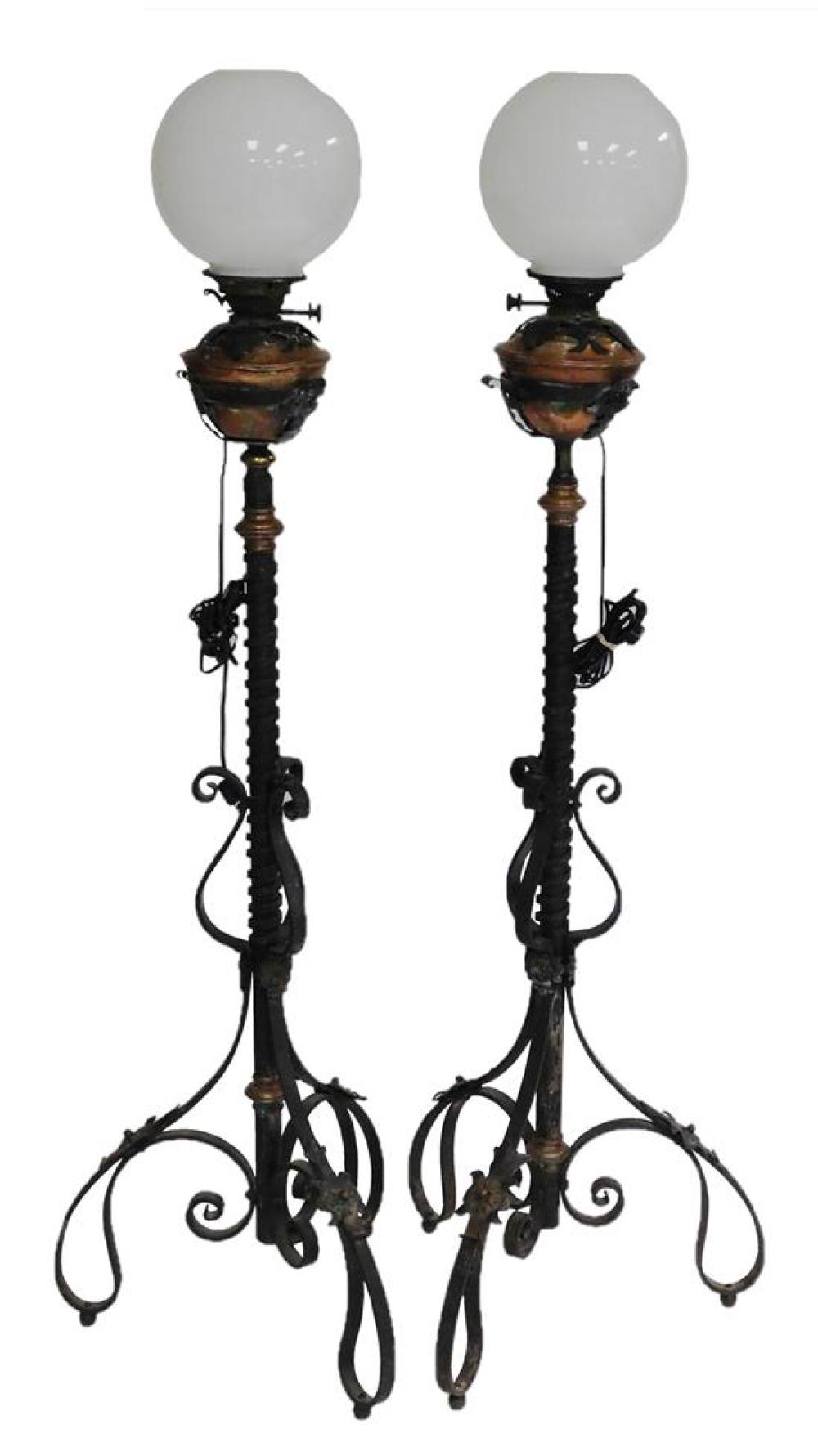 Appraisal: Two French standing fluid lamps th C wrought iron copper