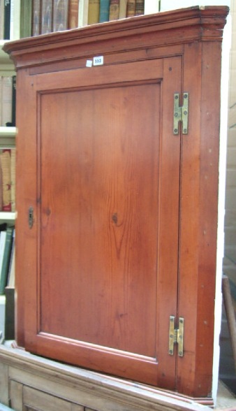 Appraisal: A th century pine hanging corner cupboard the single panel