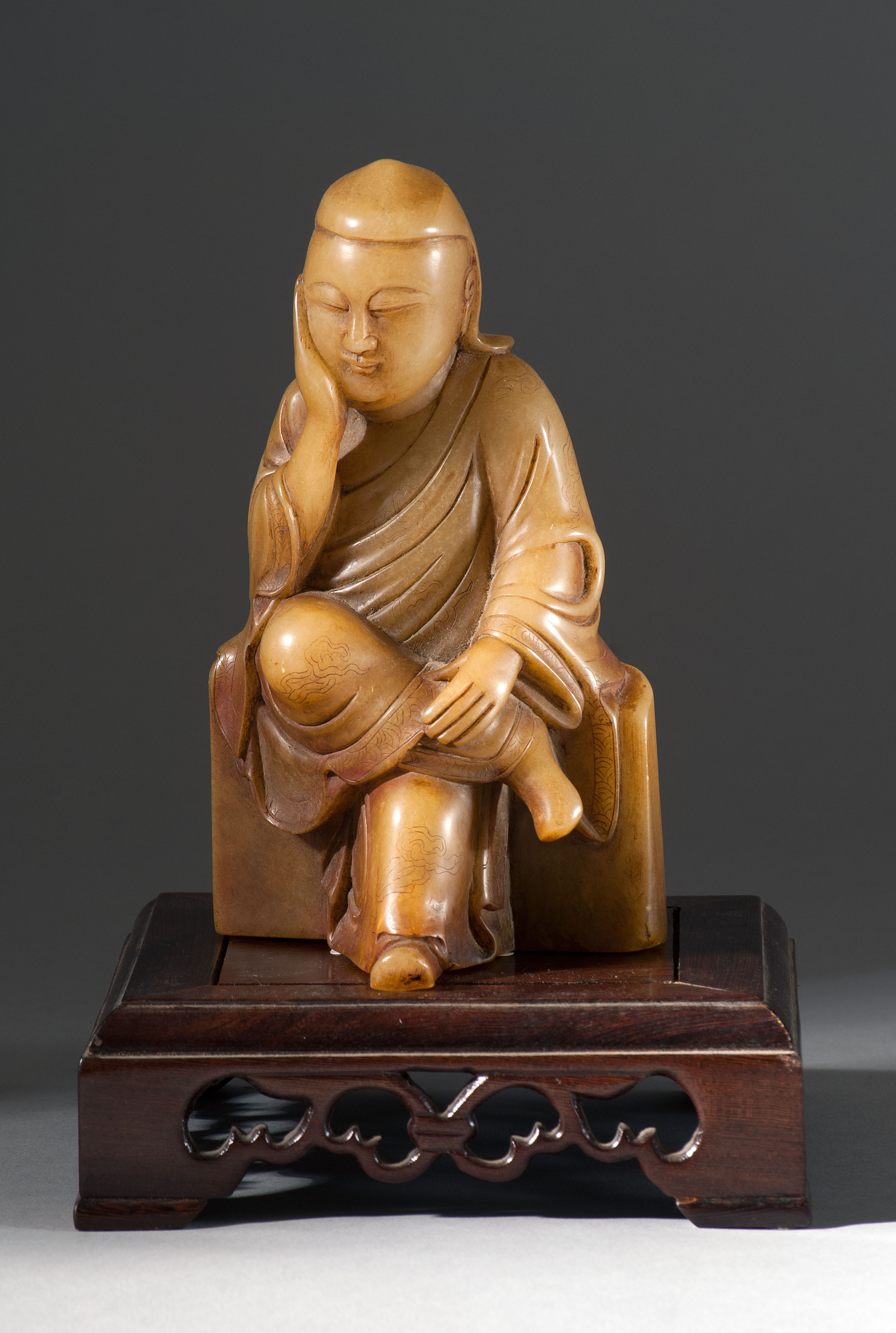 Appraisal: SOAPSTONE FIGURE OF BUDDHA th CenturySeated on a rectangular stone