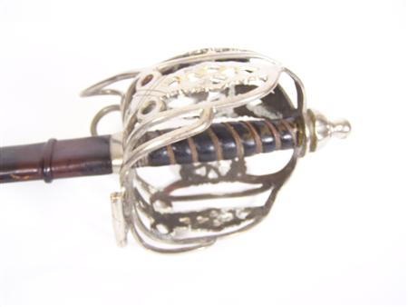 Appraisal: A basket hilted broad sword the leather grip bound with