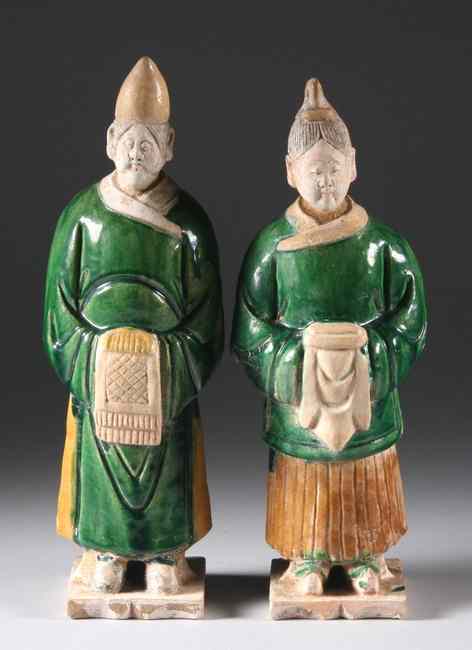 Appraisal: TWO CHINESE SANCAI EARTHENWARE FIGURES OF ATTENDANTS Ming dynasty Wearing