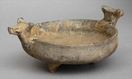 Appraisal: PERSIAN SMALL TERRACOTTA BOWL Of shallow form with bull heads