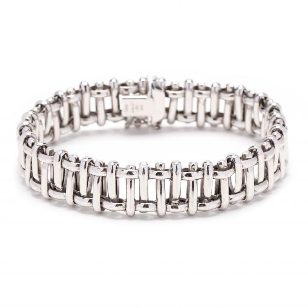 Appraisal: White Gold Bracelet Designed in an open woven motif completed