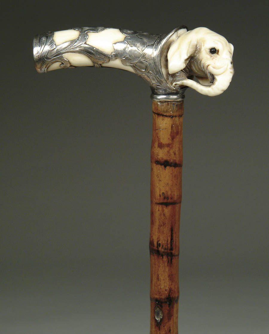 Appraisal: CARVED IVORY AND STERLING ELEPHANT CANE T-shaped handle having a