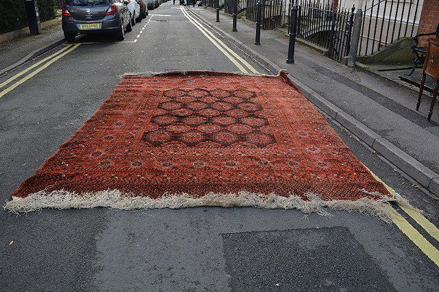 Appraisal: A large Afghan red ground carpetwith allover elephant foot designs