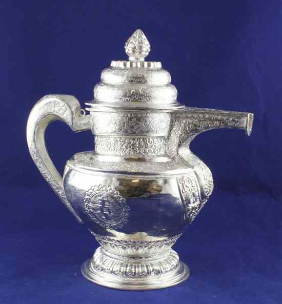 Appraisal: An Indian white metal coffee pot engraved with scrolling foliage