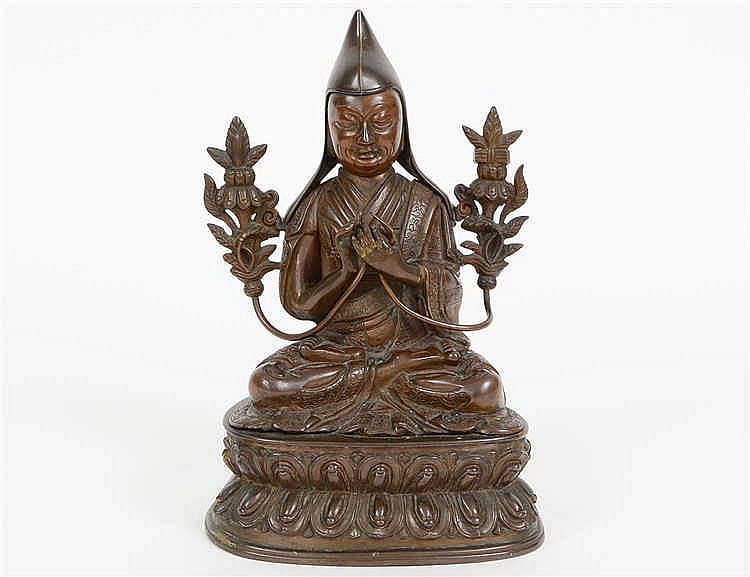 Appraisal: TIBETAN PATINATED BRONZE SEATED LAMADressed in robes with pointed cap