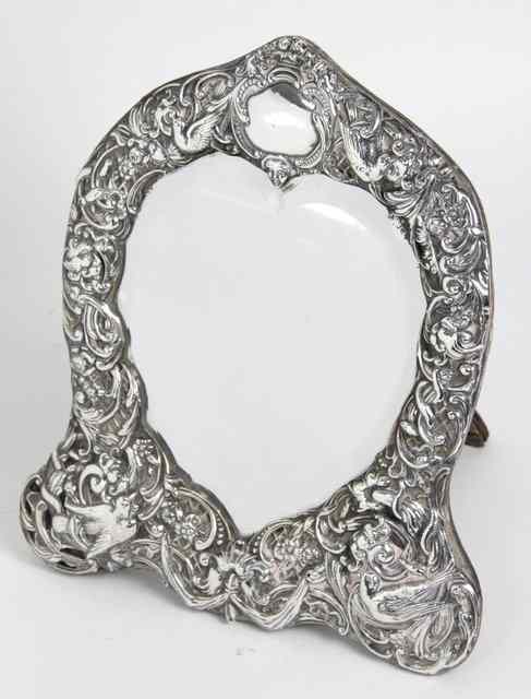 Appraisal: A silver framed heart shaped easel mirror London the frame