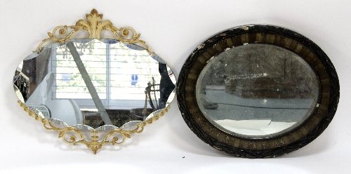 Appraisal: An oval wall mirror with scrolling crest and another mirror