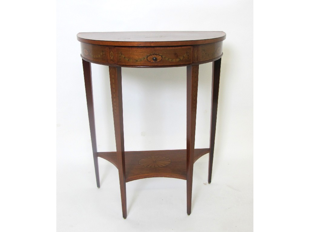 Appraisal: An Edwardian mahogany inlaid demi lune table the top richly