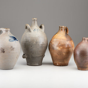 Appraisal: Four Stoneware Jugs th Century comprising three American one-handled jugs