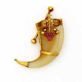 Appraisal: A ct gold mounted ruby set tiger claw brooch approximately