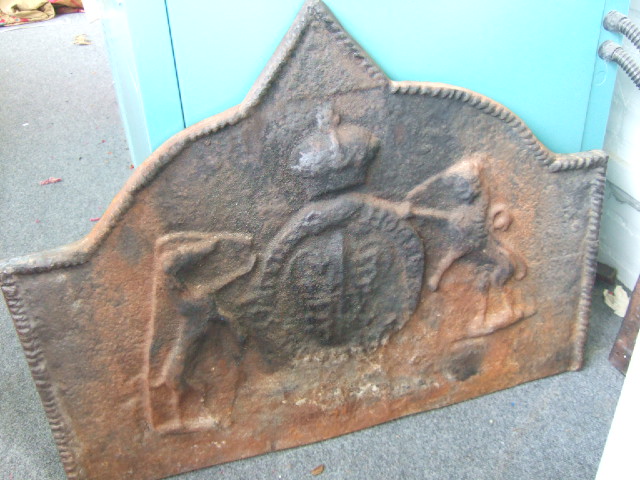 Appraisal: A cast iron fire back th century relief moulded with