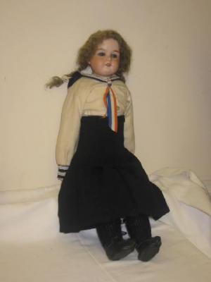 Appraisal: An Armand Marseille bisque shoulder head girl doll with blue