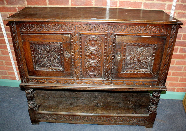 Appraisal: AN ANTIQUE CARVED OAK CHEST ON STAND with two panelled