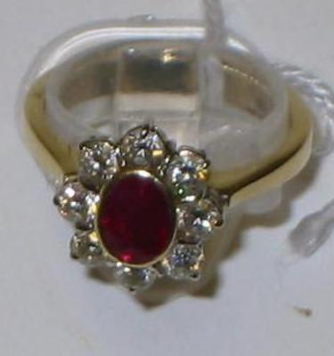 Appraisal: A RUBY AND DIAMOND CLUSTER RING the oval facet cut