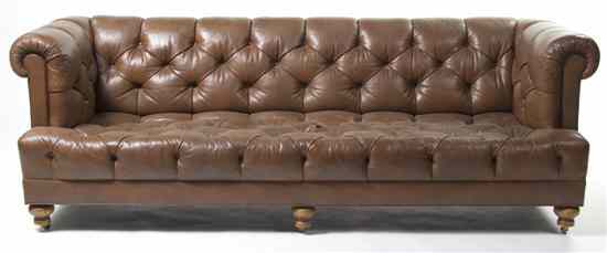 Appraisal: A Leather Upholstered Sofa having a button tufted back arms