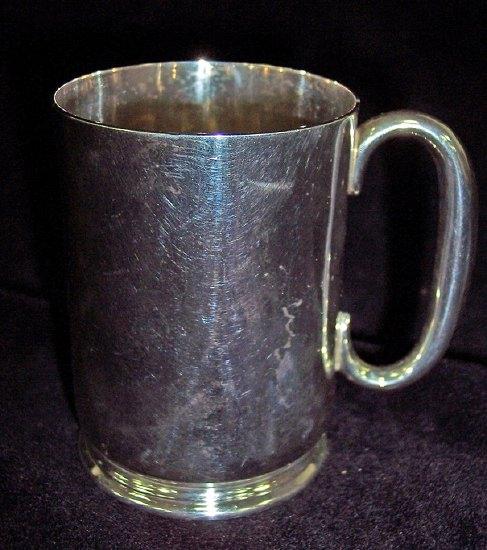 Appraisal: A plain Christening mug on a skirt base cm high