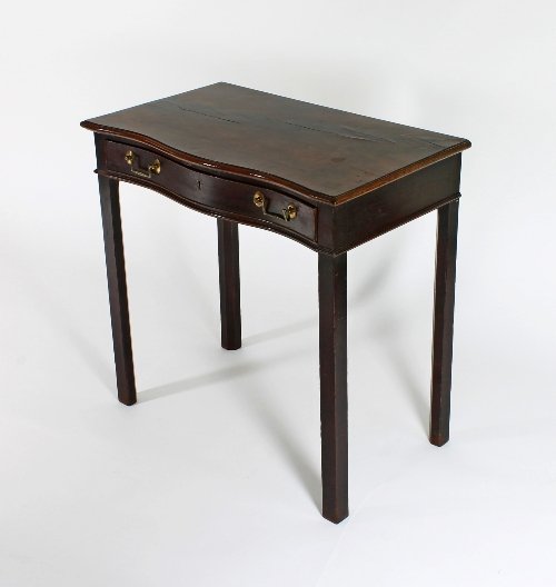 Appraisal: A George III mahogany serpentine front side table fitted a