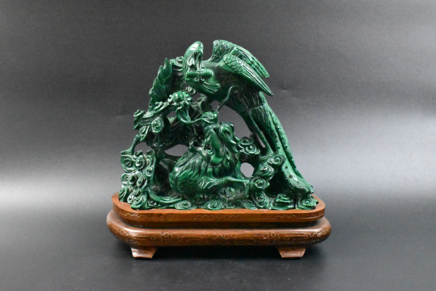 Appraisal: A Chinese malachite carving with a large phoenix holding a