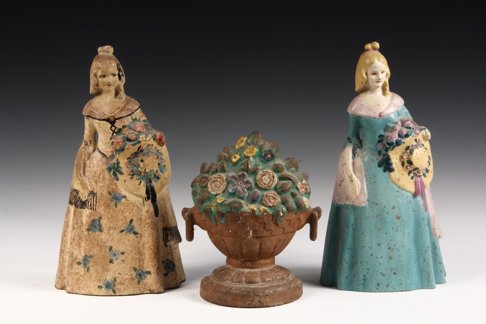 Appraisal: FIGURAL IRON DOORSTOPS - Southern Belles in different paint schemes