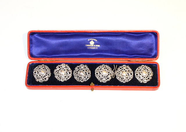 Appraisal: A SET OF SIX SILVER BUTTONS with pierced foliate decoration