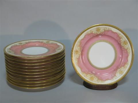 Appraisal: TWELVE HEUSTCHREUTHER PINK AND GILT PLATES White centers encircled by