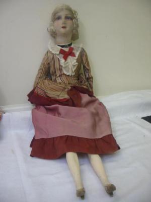 Appraisal: A Continental boudoir doll with moulded fabric face painted eyes