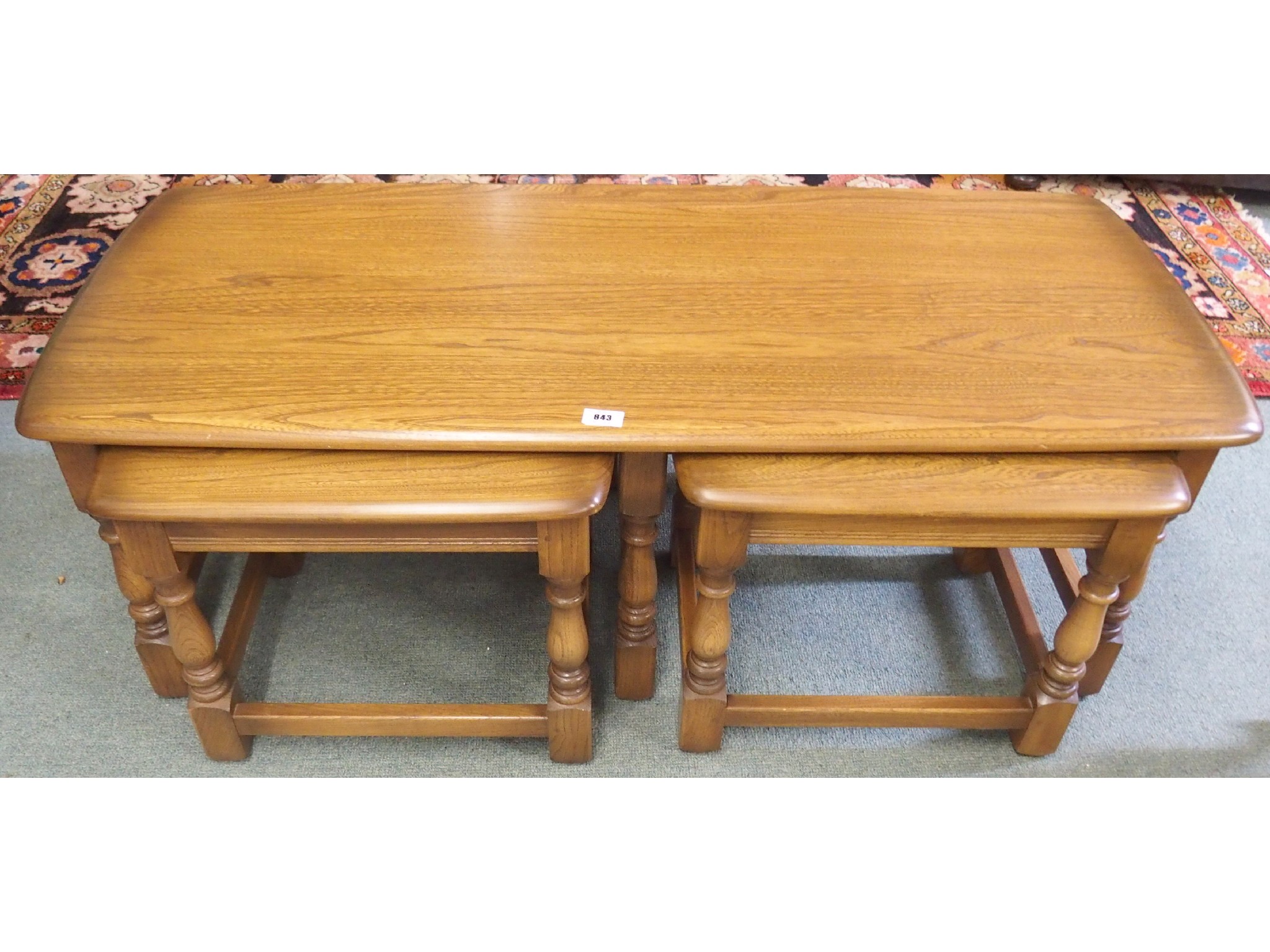 Appraisal: A contemporary Ercol oak coffee table with two side tables