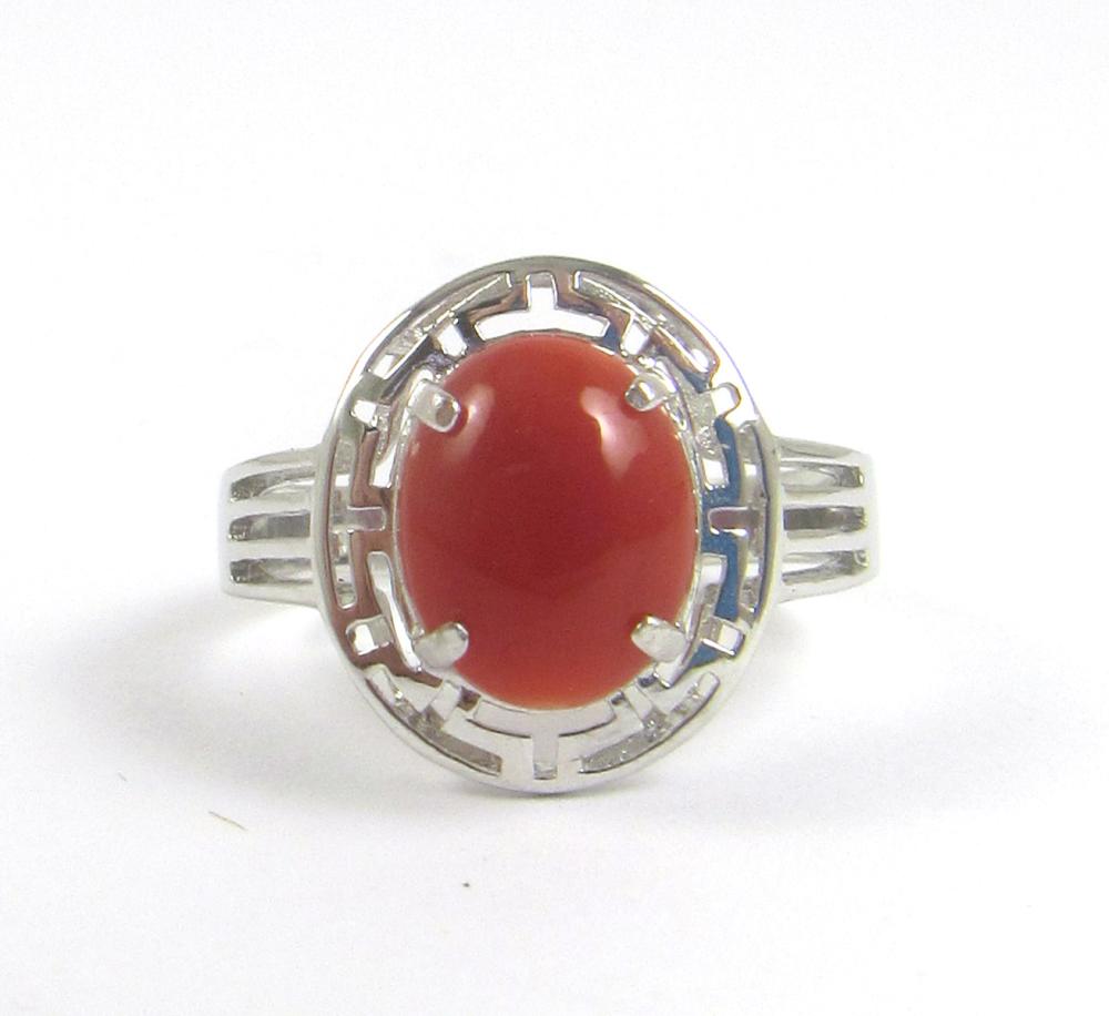 Appraisal: CORAL AND FOURTEEN KARAT WHITE GOLD RING with four white