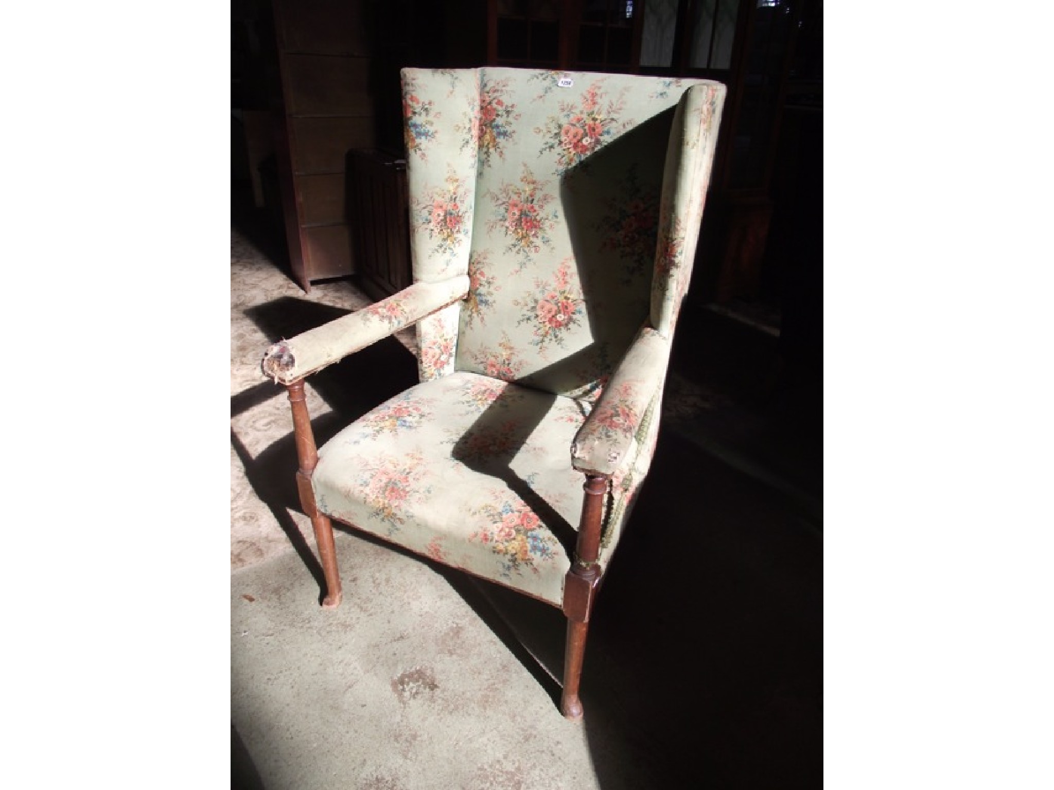 Appraisal: An Arts Crafts wing back open armchair with upholstered finish