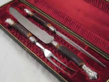 Appraisal: An antler handled carving set in original velvet and ruched