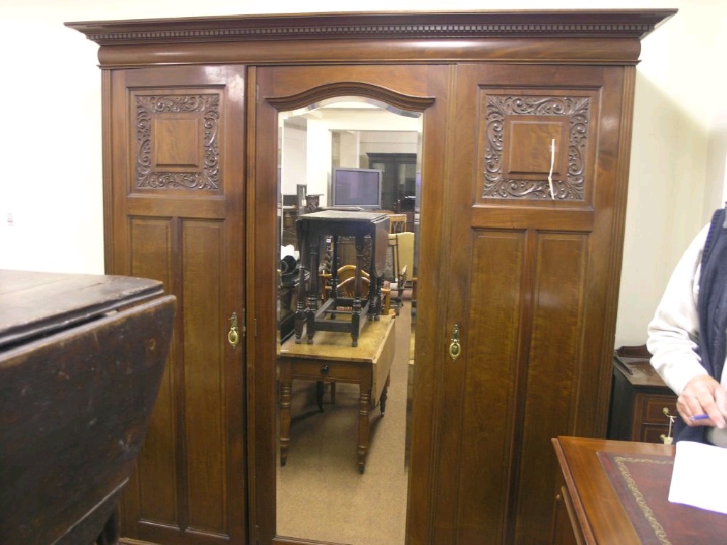 Appraisal: A late Victorian mahogany wardrobe central full-length bevelled mirror door