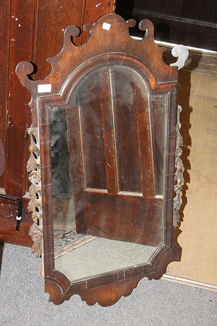 Appraisal: A GEORGE I STYLE FRET WALL MIRROR with carved giltwood