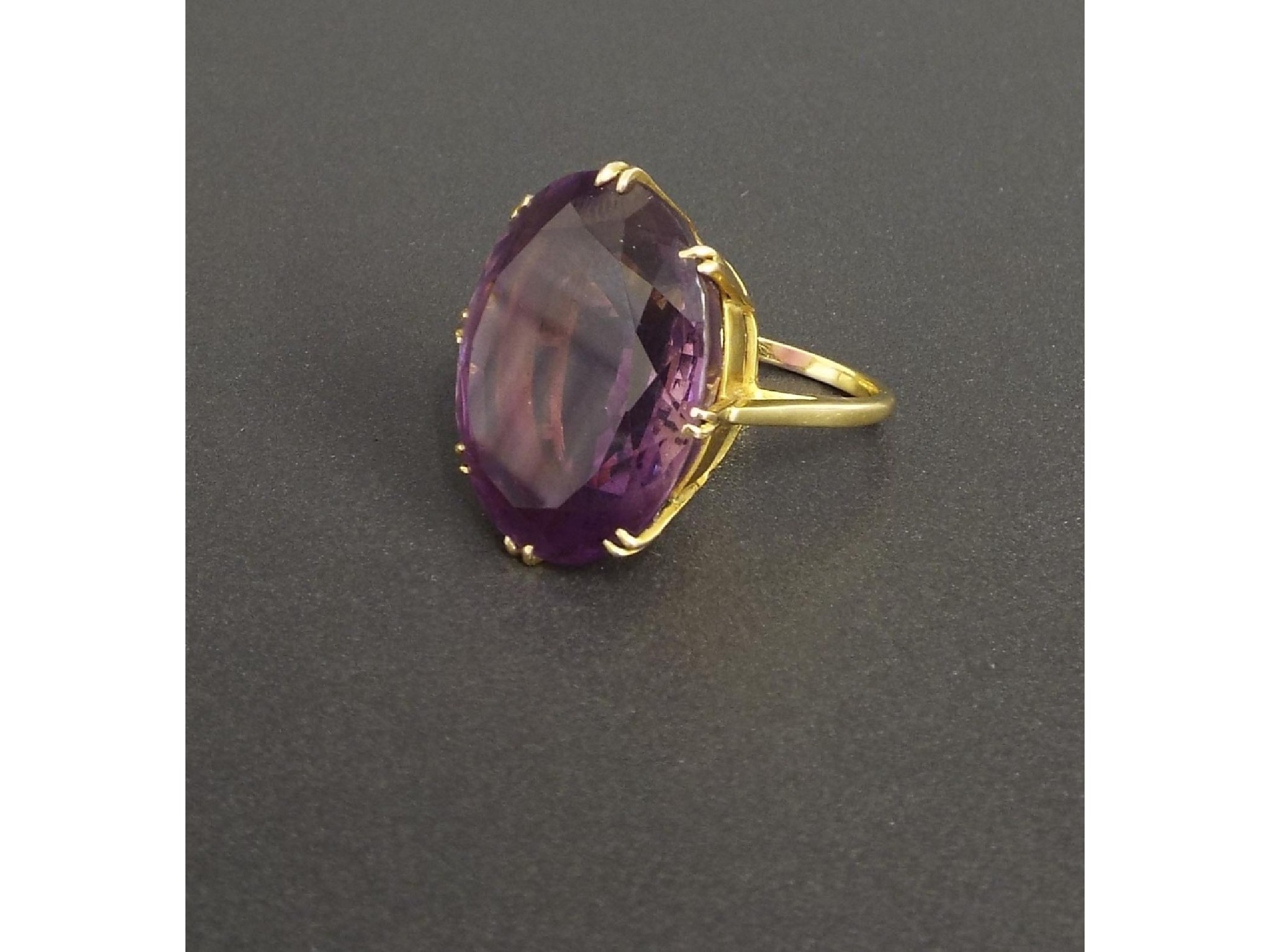 Appraisal: Large k oval amethyst single stone dress ring the amethyst