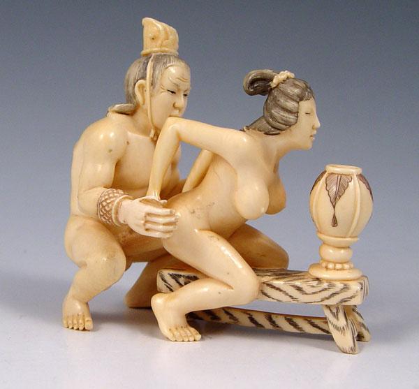 Appraisal: A PIECE EROTICA CARVED IVORY OKIMONO Graphic erotic netsuke with