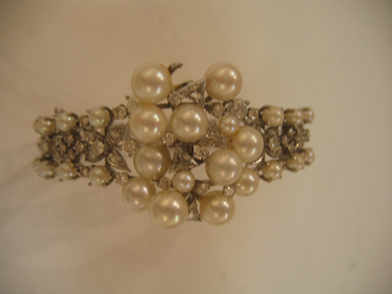 Appraisal: PEARL AND DIAMOND BANGLE BRACELET k white gold bracelet with