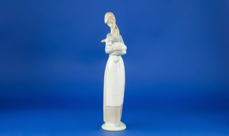 Appraisal: Lladro Figure Girl Holding a Lamb inches high