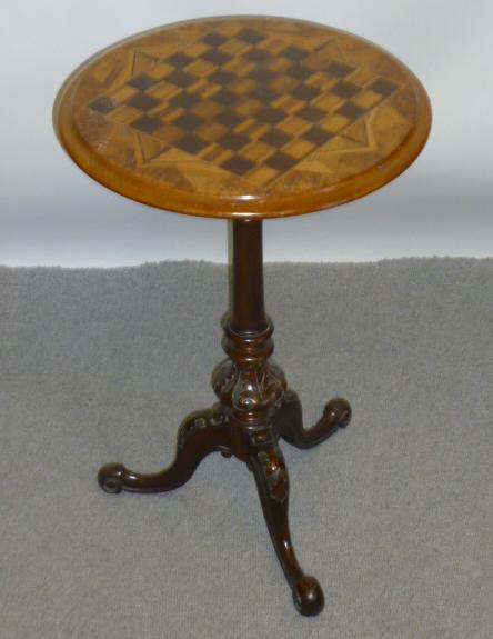 Appraisal: A VICTORIAN WALNUT GAMES TABLE the moulded edged circular top