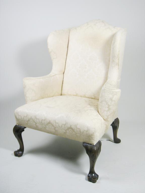 Appraisal: A Georgain style Winged Armchair with leafage pattern upholstery on