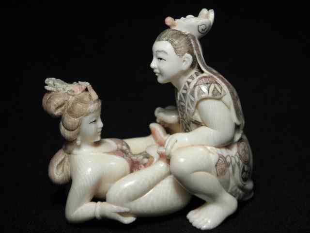 Appraisal: Japanese carved ivory erotic netsuke group Depicts a man and