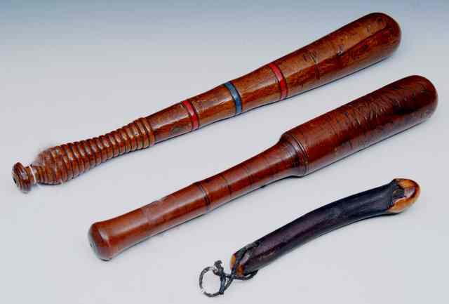 Appraisal: A TURNED WOOD of plain form a similar wooden truncheon