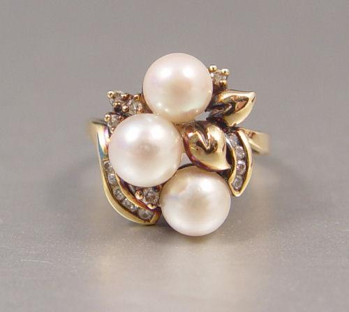 Appraisal: PEARL AND DIAMOND RING K yellow gold ring contains three